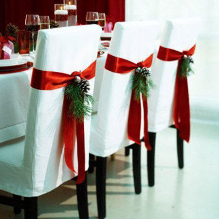 White chairs with evergreen details for Christmas