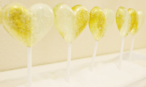 We Love these gold glitter lollipops we had at our Lucky In Love Engagement Party- B. Lovely Events