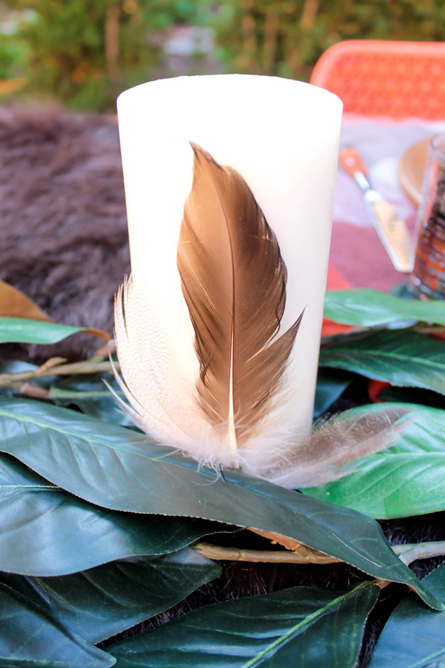 Lovely Feather Decorated Candles on this fabulous outdoors tablescape- See More Woodsy Tablescape Details On B. Lovely Events