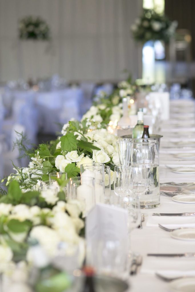 LOVE this headtable with all white roses - See all the beautiful details on B. Lovely Events! #wedding #realwedding #weddingideas #weddingtips #weddingdecorations